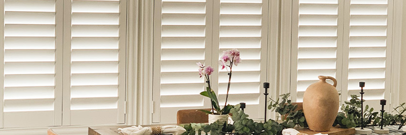 White polywood shutters in a dining room