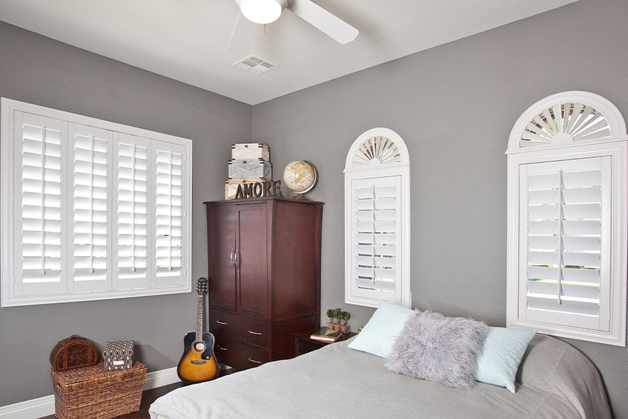 White Polywood shutters in a large bedroom.