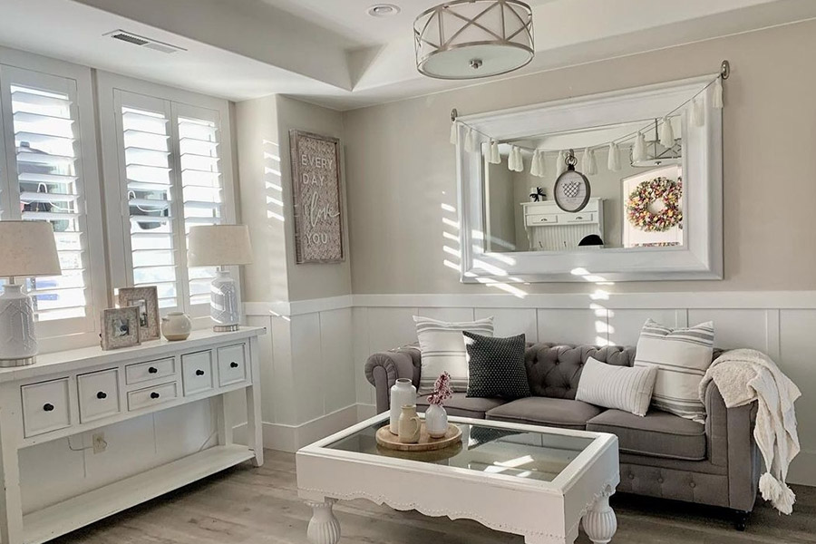 White Polywood shutters in a shaded living room.